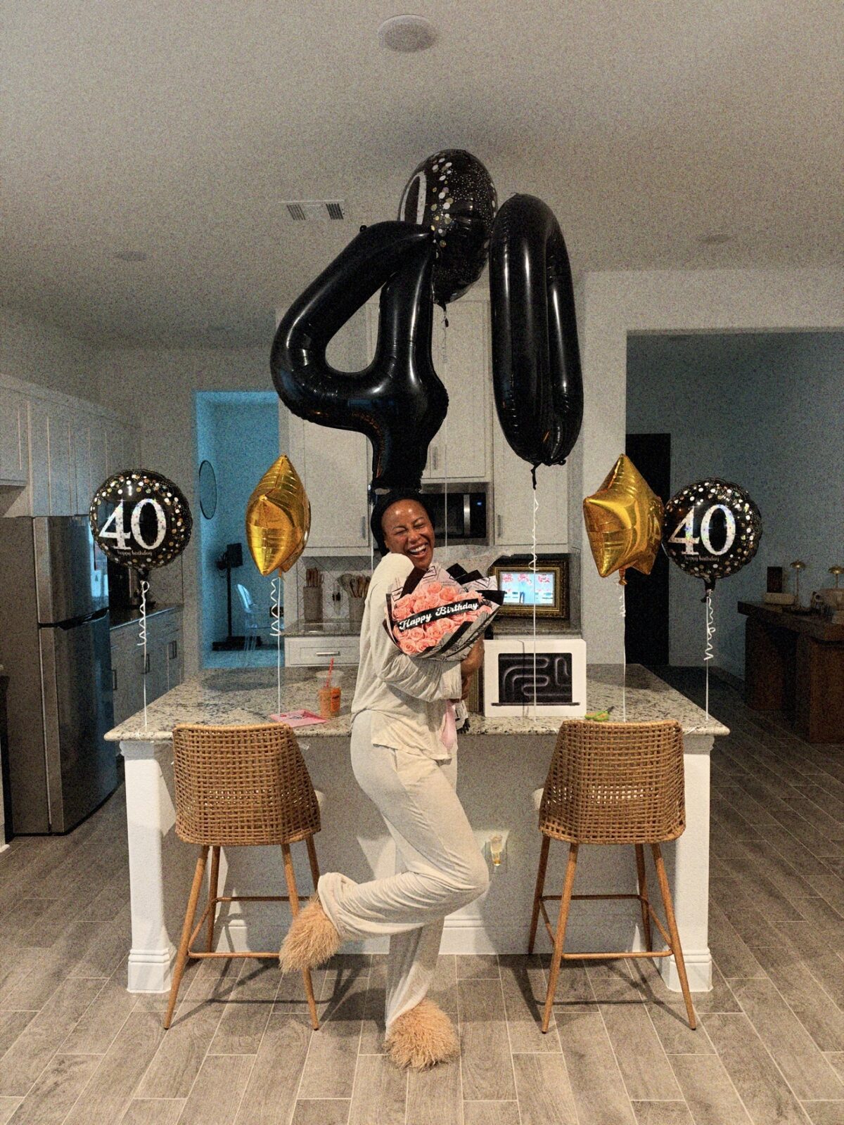 Ashley Shannet in a kitchen with silver 40 balloons